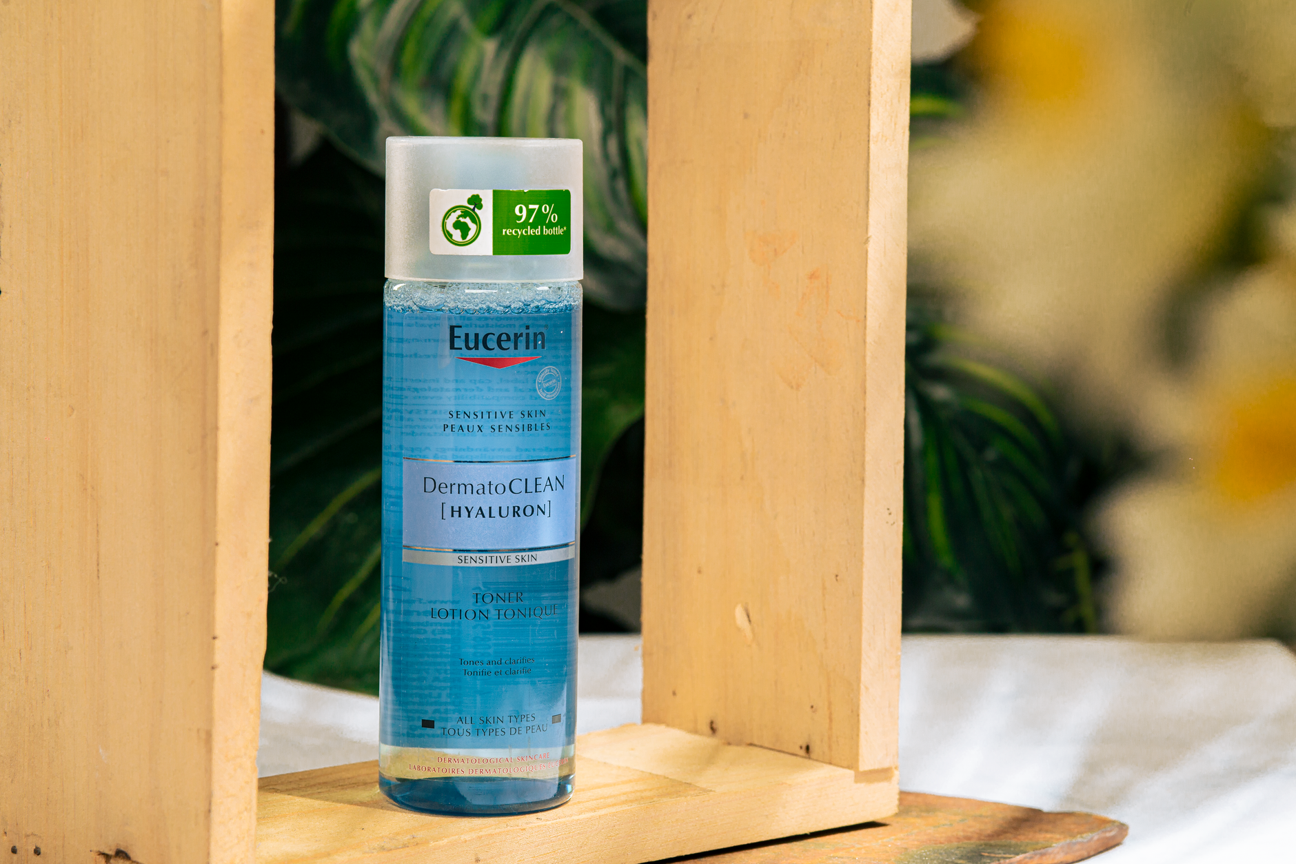 A person gently applying a skincare product to their cheek.